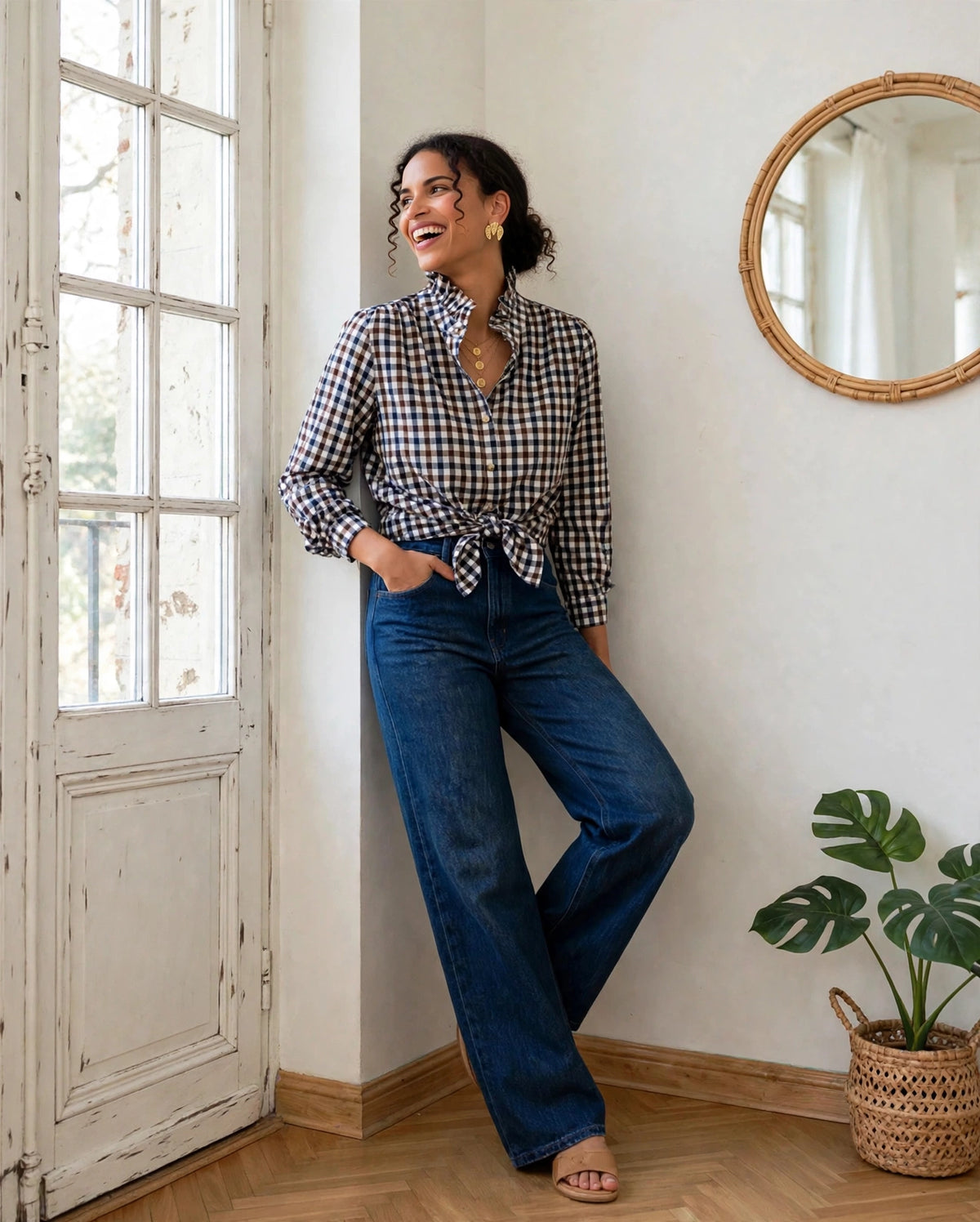 Chemise Romy à carreaux vichy nouée à la taille, portée avec un jean large bleu et des sandales beiges.