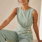 Combinaison pantalon fluide vert d'eau avec découpe asymétrique à< la taille et boucles métalliques dorées