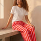 Pantalon large rayé rose et rouge en viscose et polyester, taille mi-haute avec cordon, par Esma Shop.