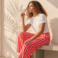 Pantalon large rayé rose et rouge en viscose et polyester, taille mi-haute élastiquée, par Esma Shop.