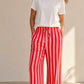 Pantalon large rayé rose et rouge en viscose et polyester, taille mi-haute avec cordon, par Esma Shop